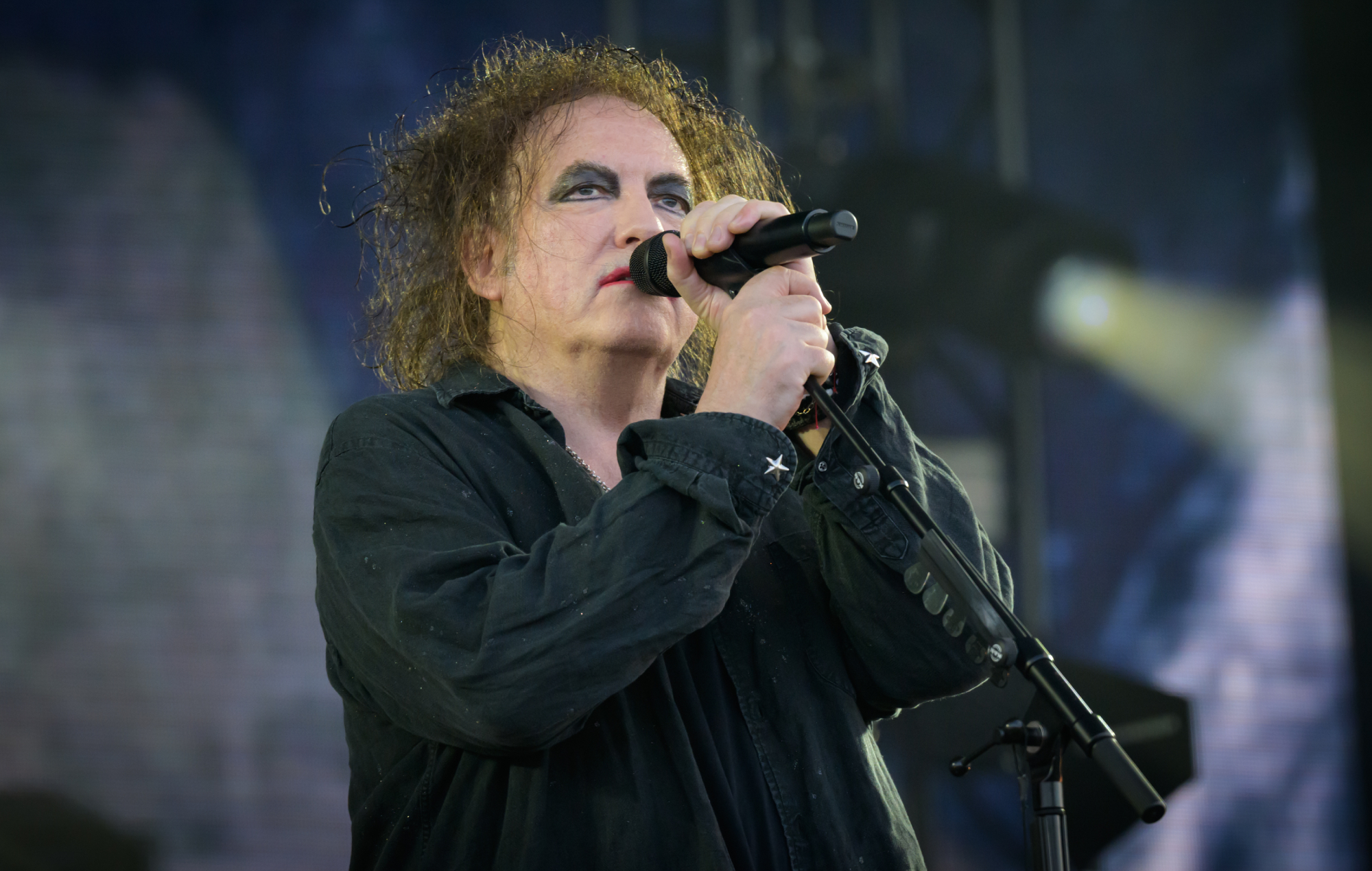 The Cure's Robert Smith performing live on stage, photo by Mark Holloway/Redferns/Getty