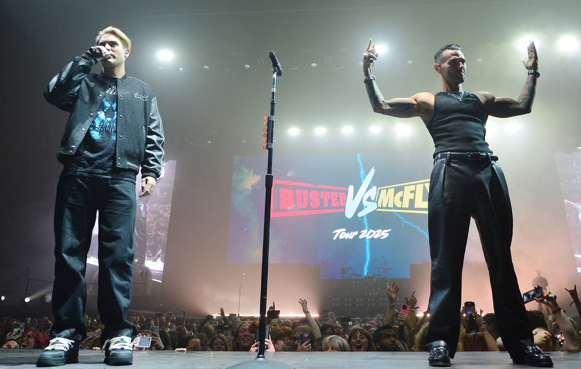 Matt Willis and Charlie Simpson of Busted storm the stage, during McFly's 21st Birthday show