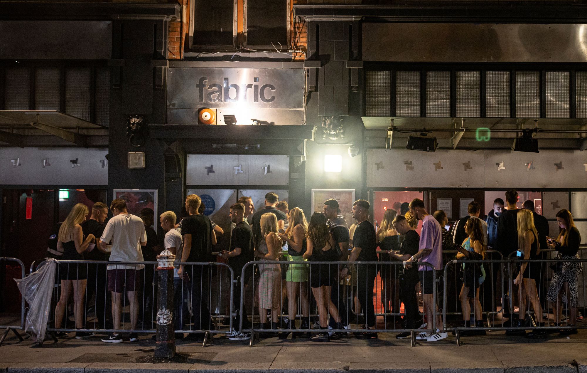 Club-goers queue outside Fabric nightclub on July 24, 2021