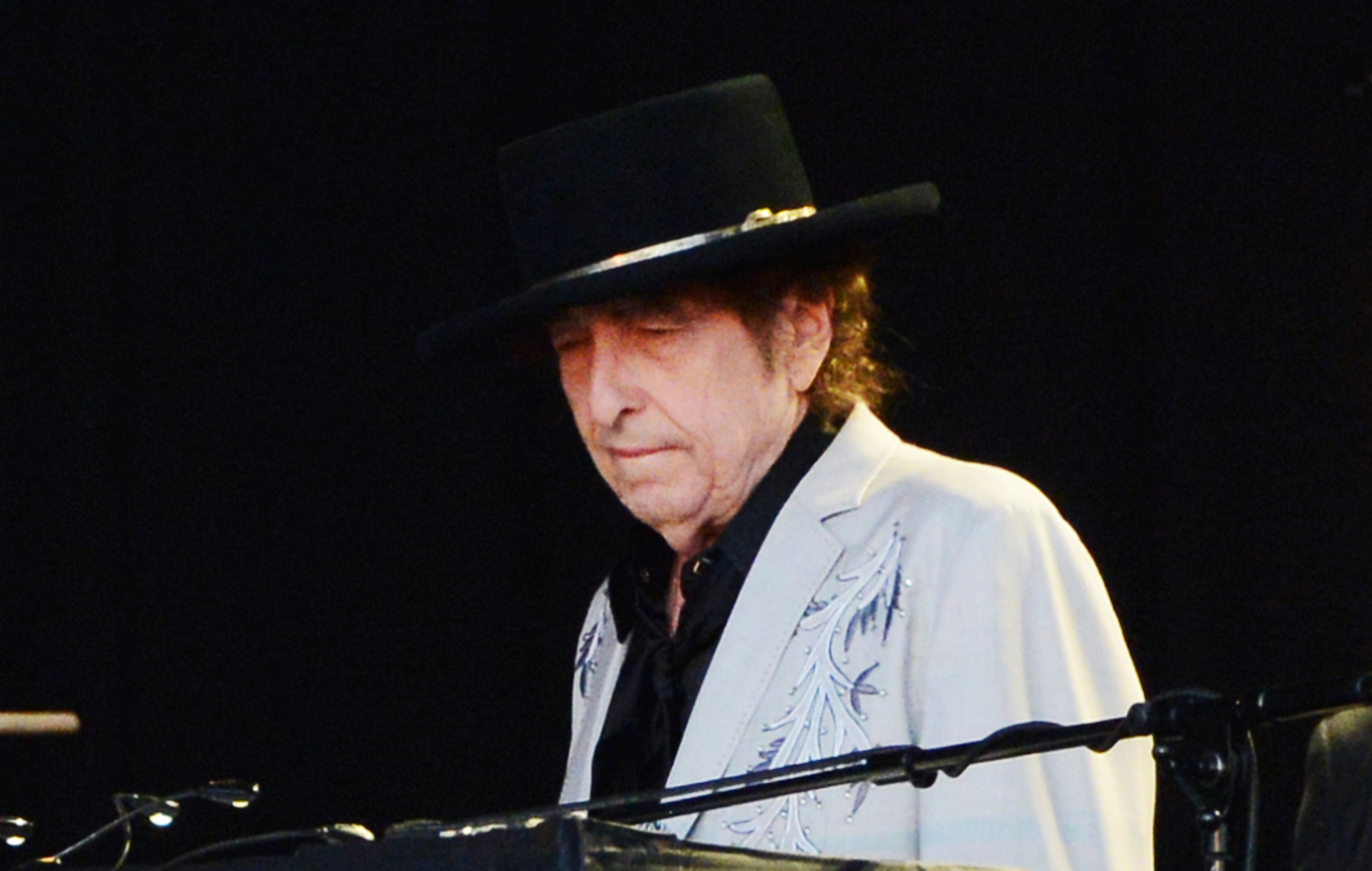 Bob Dylan performing live on stage, photo by Matthew Baker/Getty