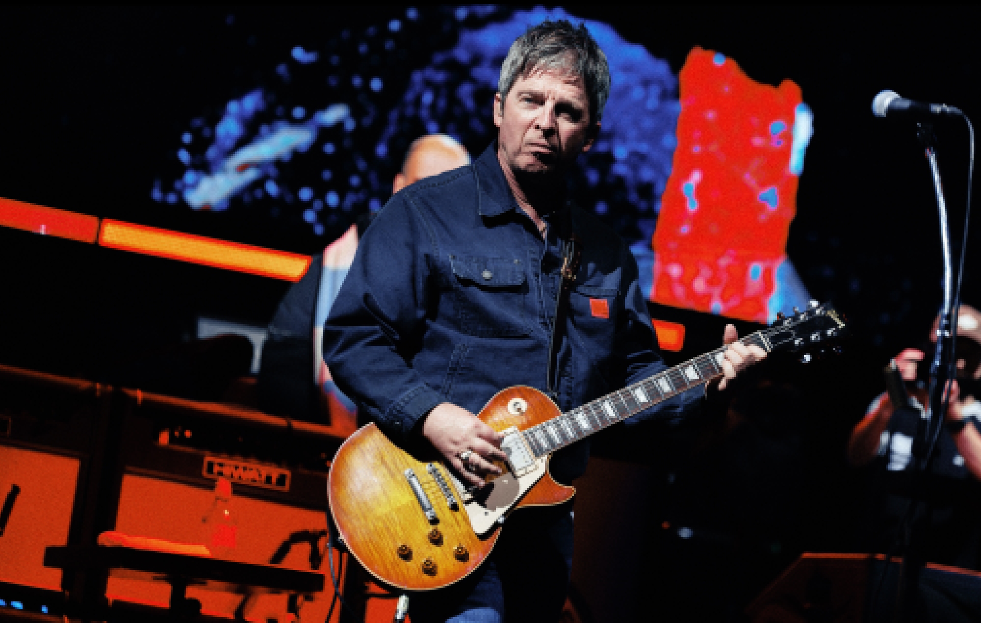 Noel Gallagher performing live on stage with Oasis, photo by Big Brother Recordings