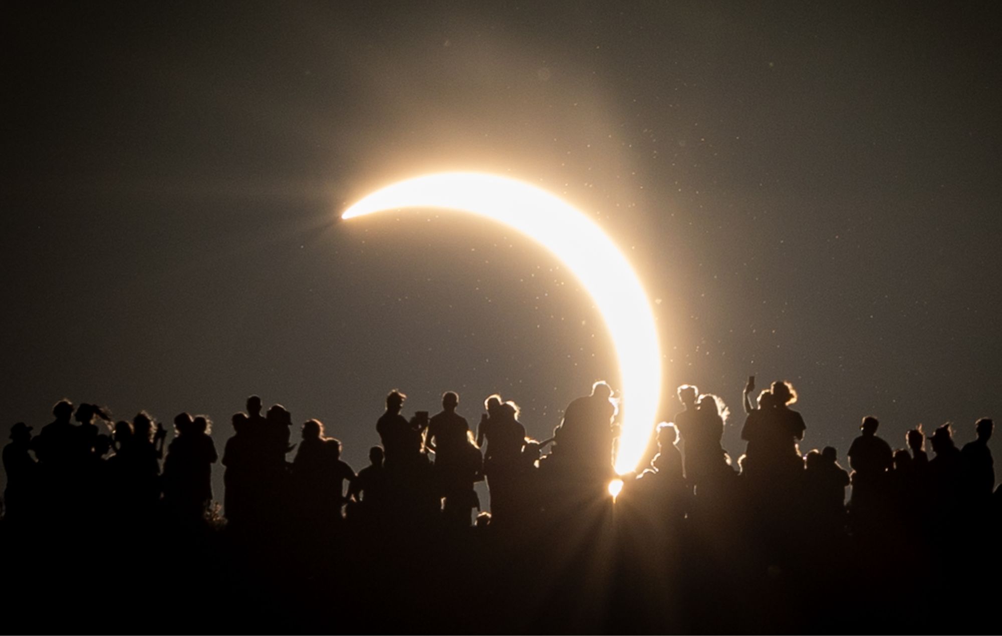People view the partial solar eclipse from the Glastonbury site