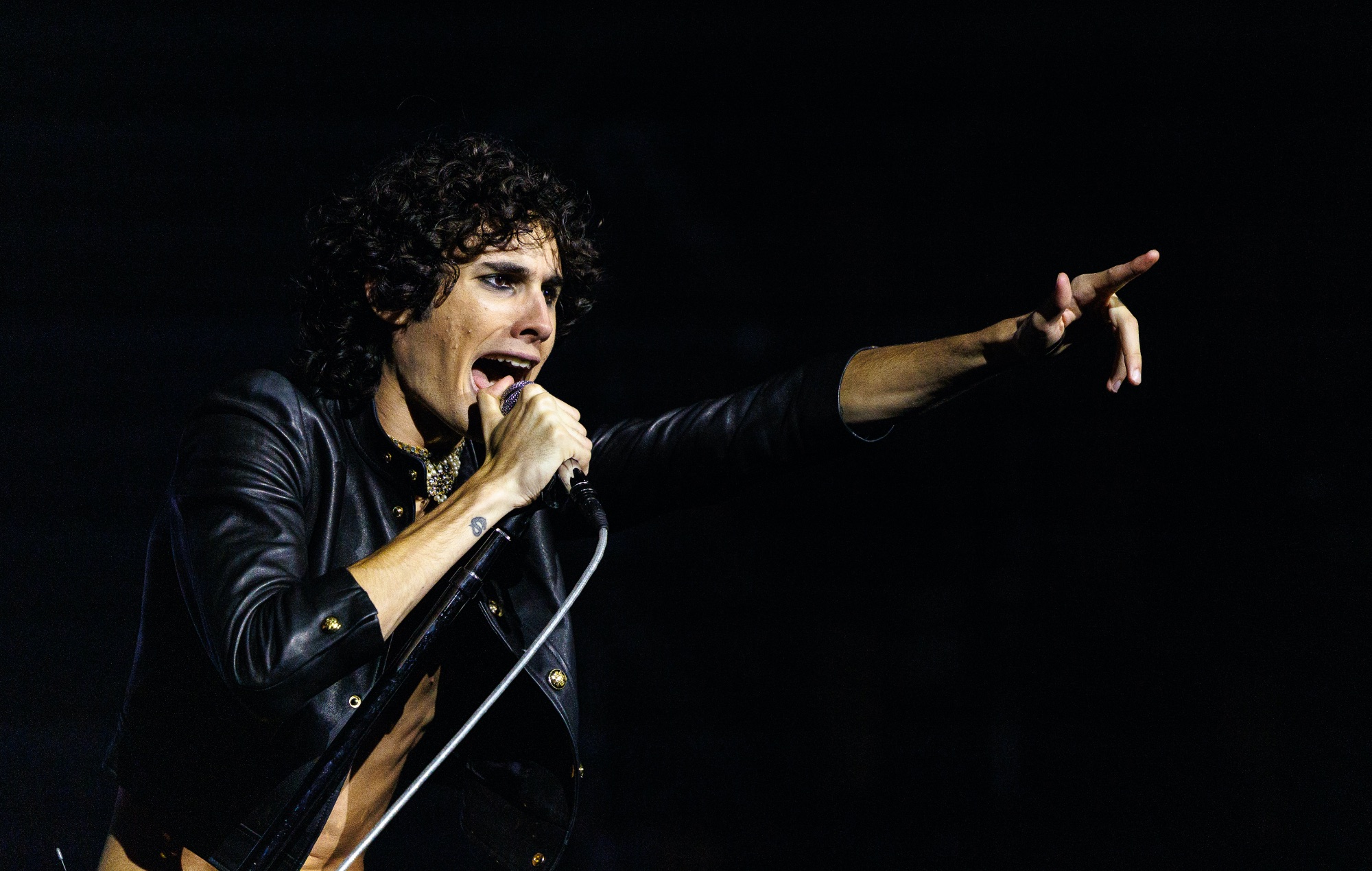 Sombr performing live on stage, photo by Marco Kost/Redferns/Getty