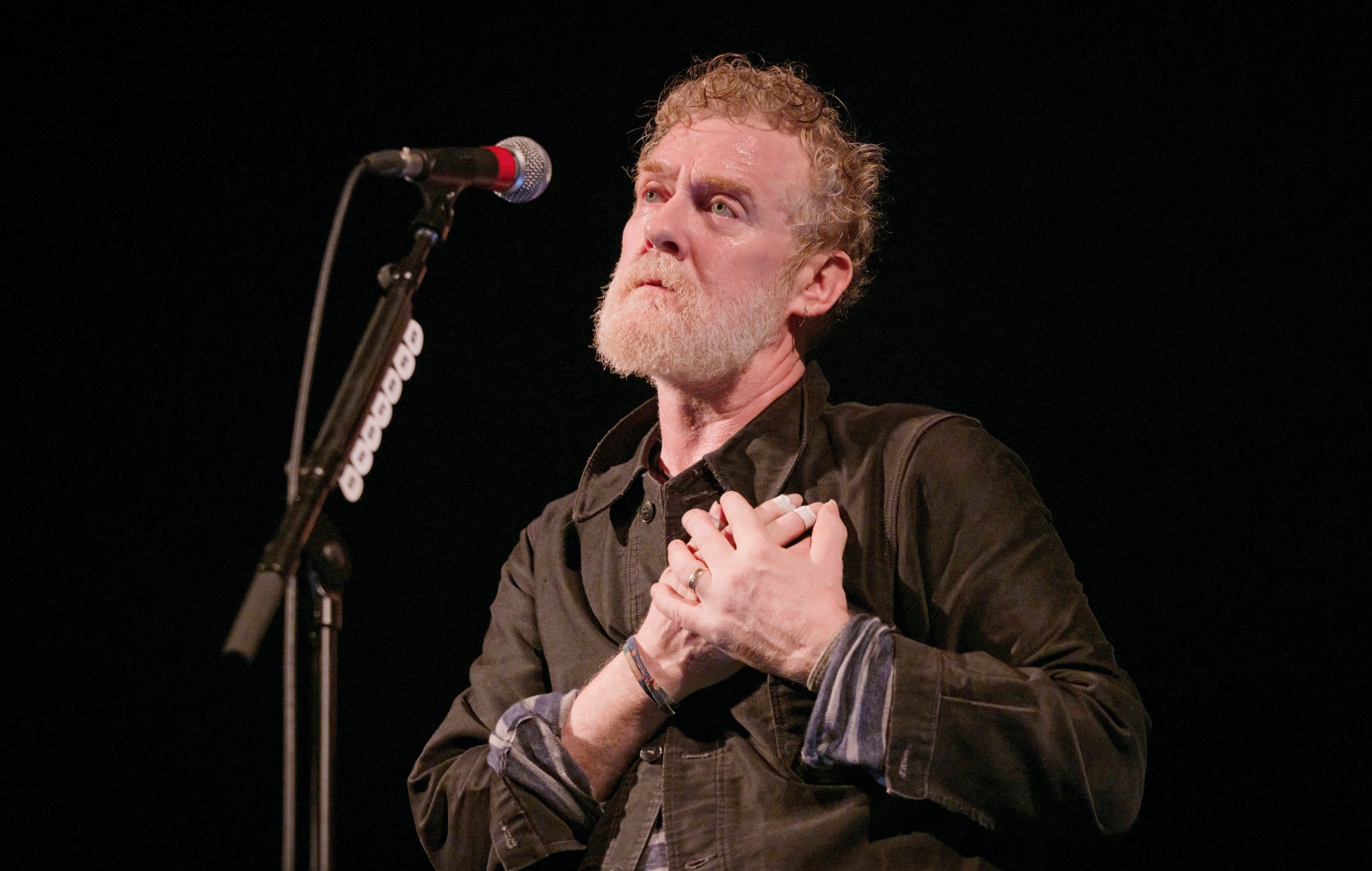 Glen Hansard performing live on stage, photo by Frank Hoensch/Redferns/Getty
