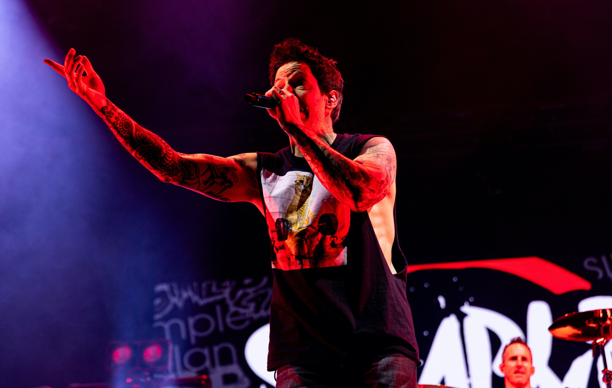 Pierre Bouvier of Simple Plan performing live on stage, photo by Mike Lewis Photography/Redferns/Getty