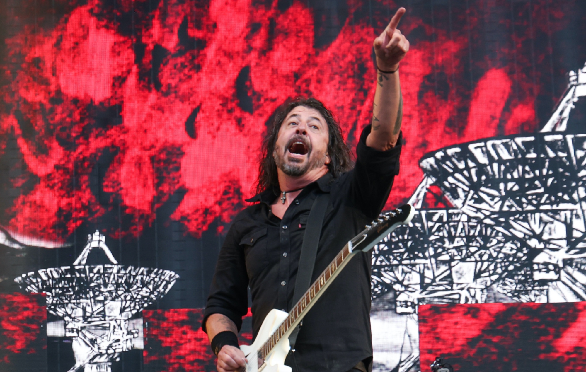 Dave Grohl performing on stage with Foo Fighters, photo by Kevin Mazur/Getty