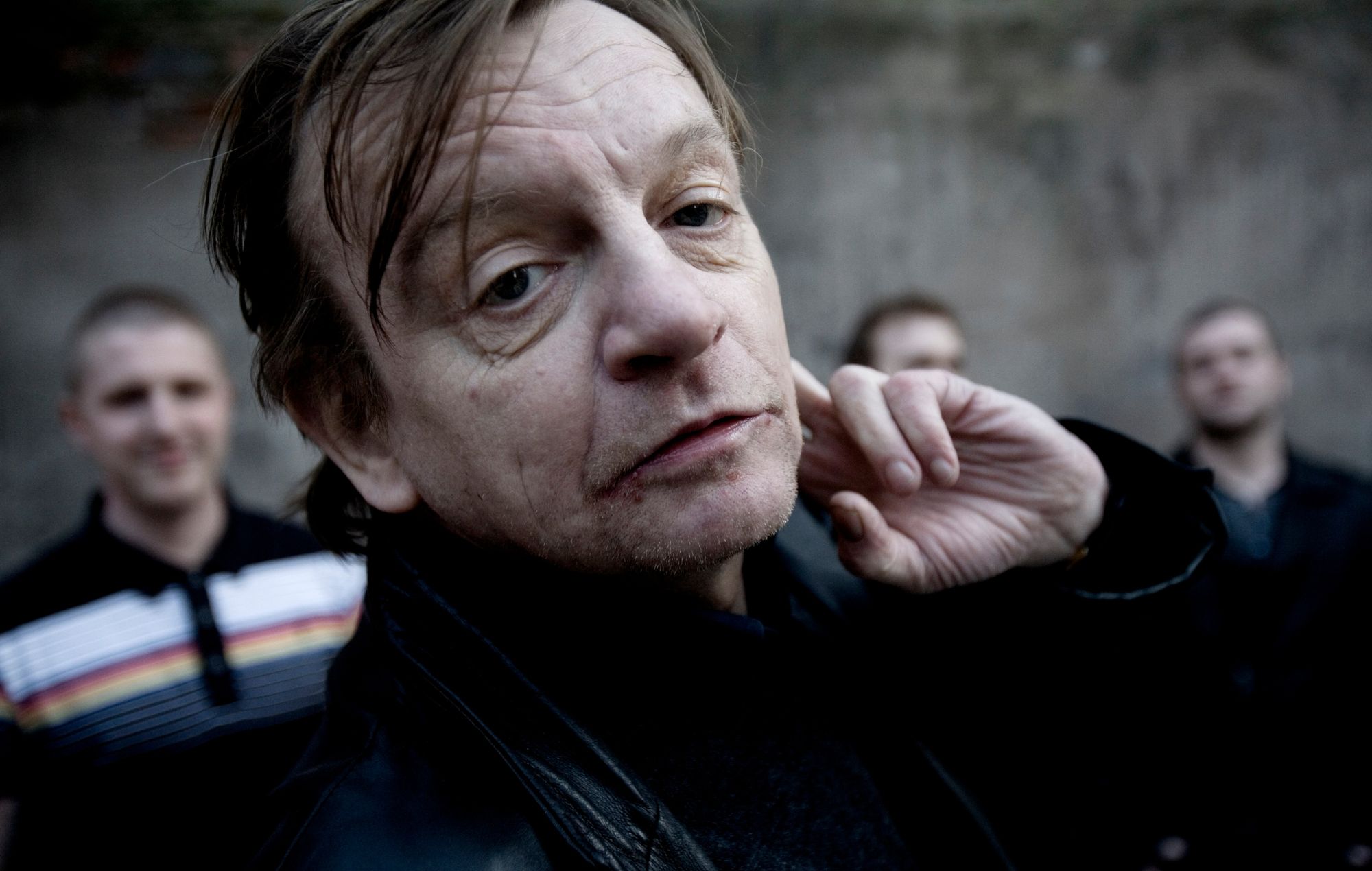 Mark E Smith poses with other members of The Fall
