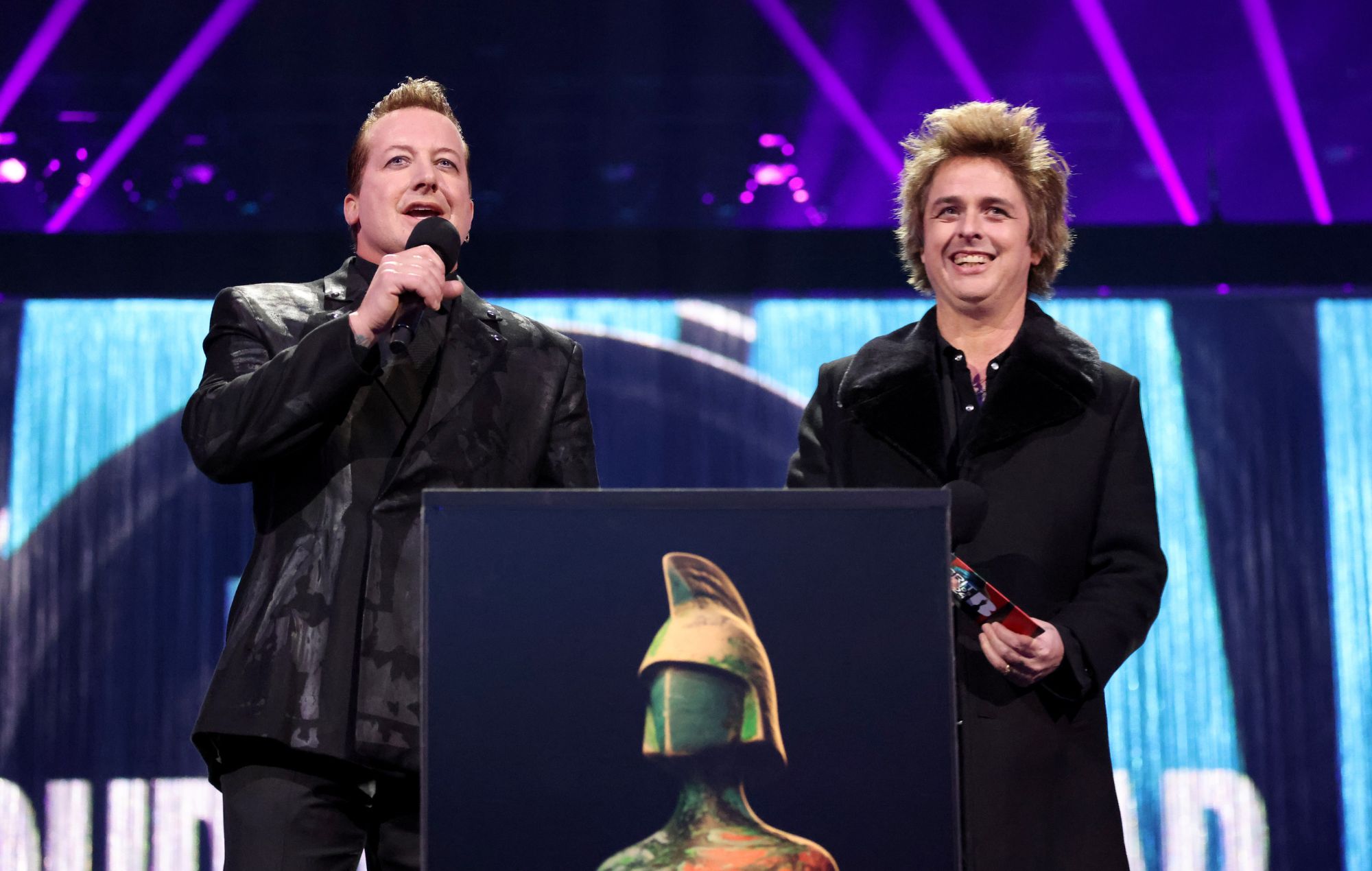 Tré Cool and Billie Joe Armstrong of Greenday present the Group of the Year award onstage during the BRIT Awards 2024 at The O2 Arena on March 02, 2024 in London, England.