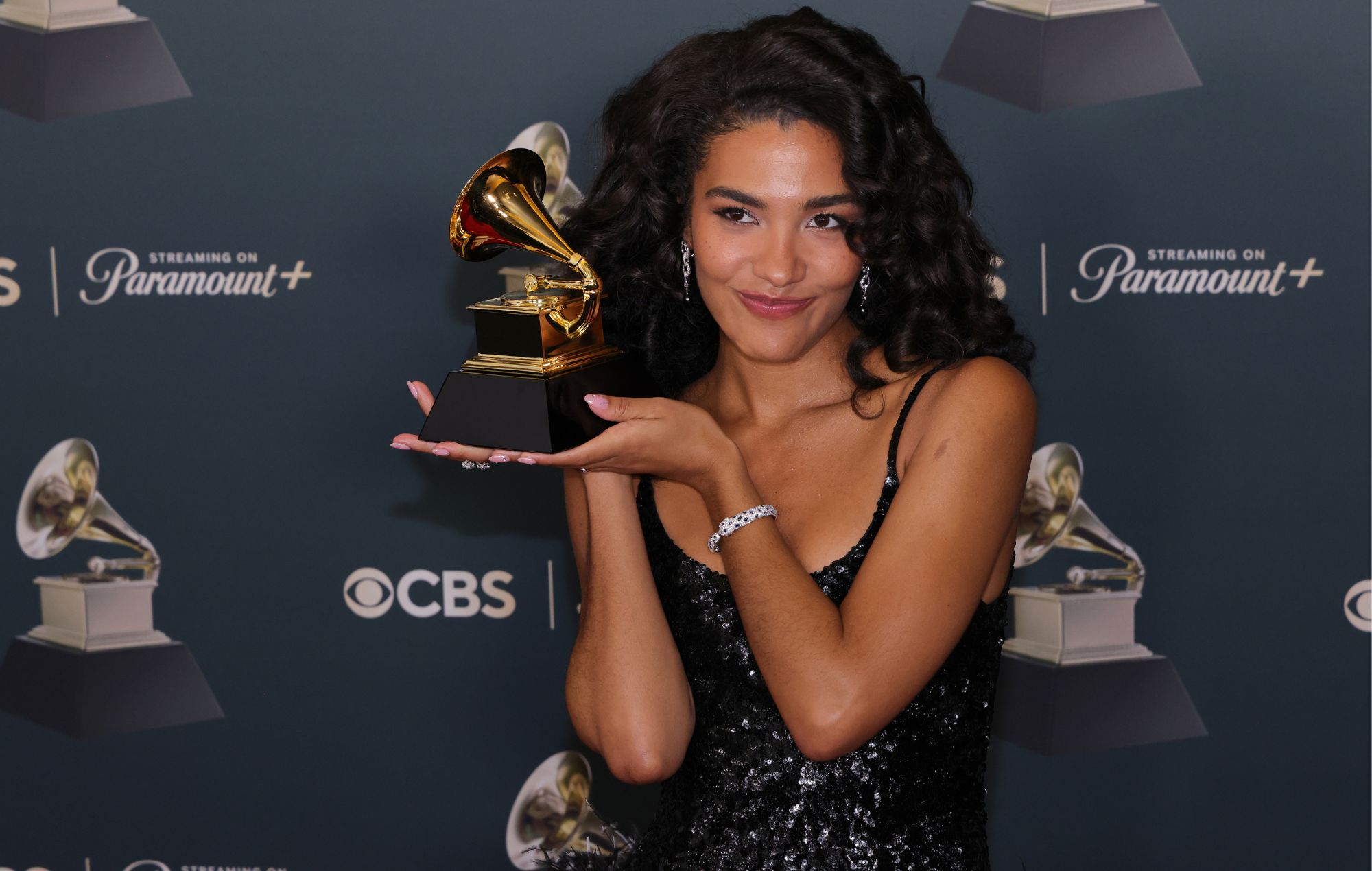 Olivia Dean holds her trophy at 2026 Grammy Awards