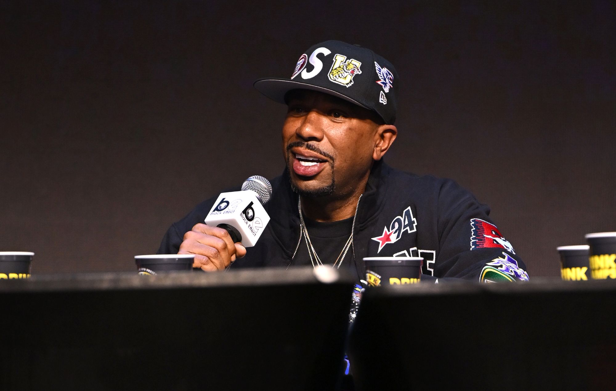 N.O.R.E speaks on stage in 2026