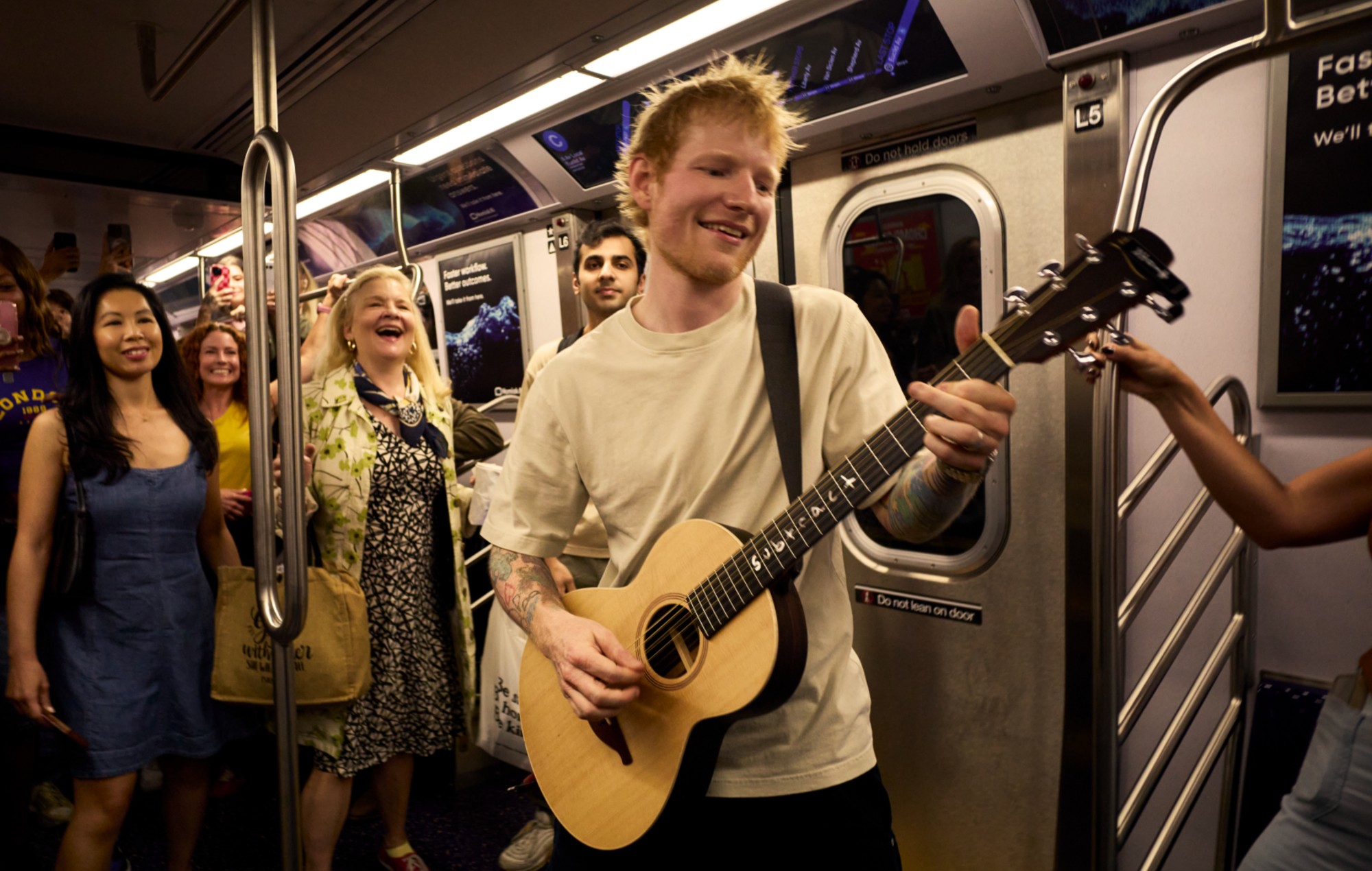 Ed Sheeran performing on the subway in New York in 'One Shot With Ed Sheeran'