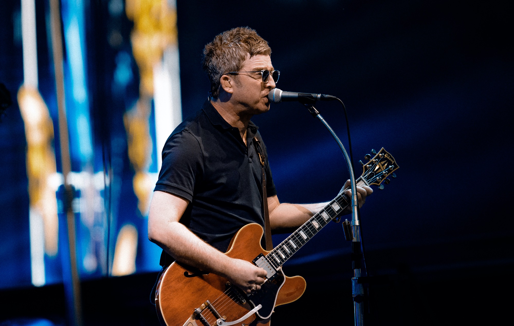 Noel Gallagher performing live on stage with Oasis at Manchester's Heaton Park 