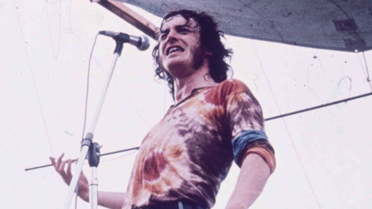 Joe Cocker performing onstage at the Woodstock Festival in 1970